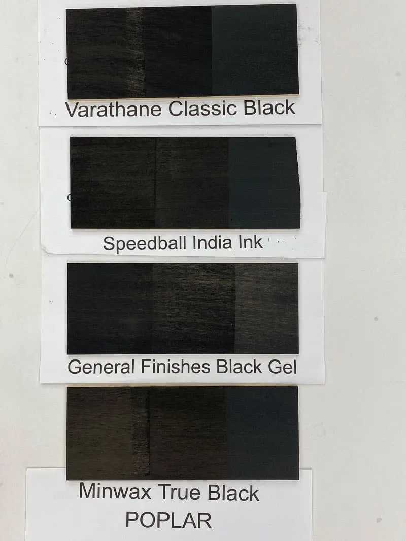 four black wood stain samples on poplar