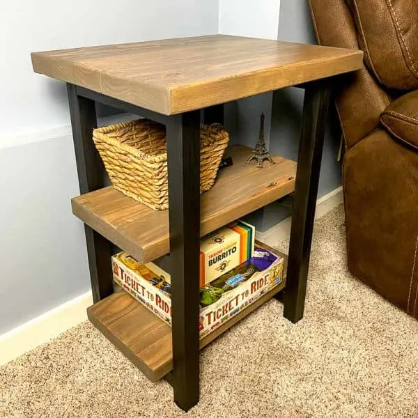 DIY rustic end table next to brown recliner