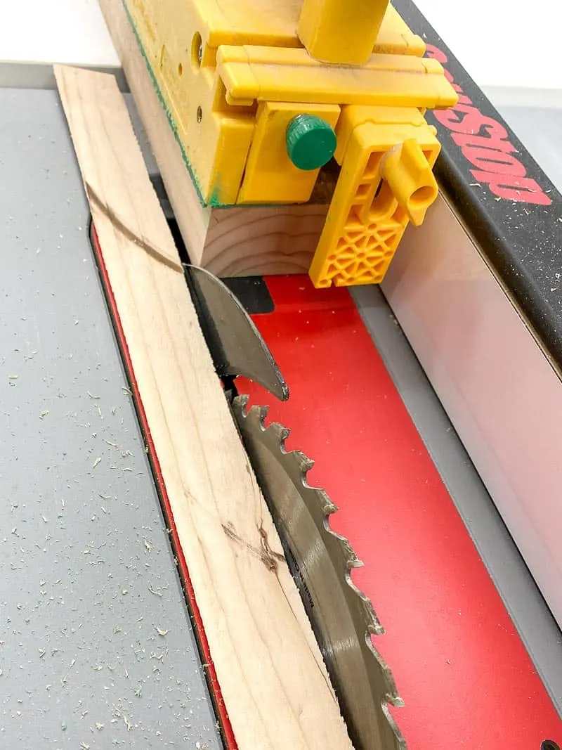 trimming rounded edges off 2x4 board at the table saw