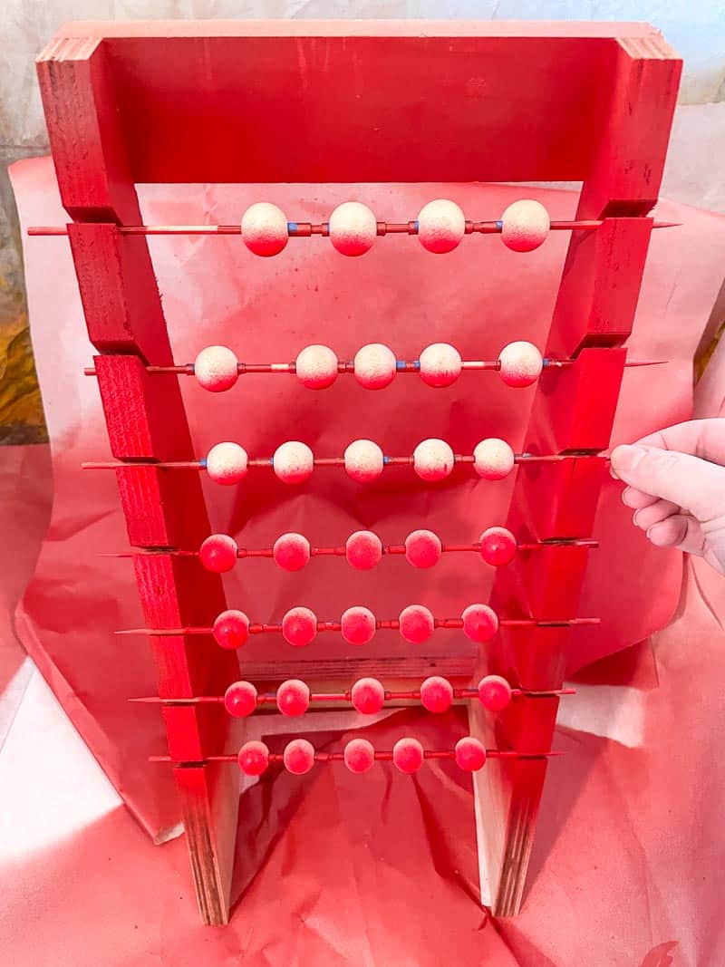 turning painted beads on sticks