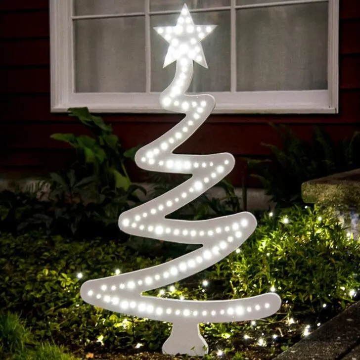 DIY wood Christmas tree with lights in yard