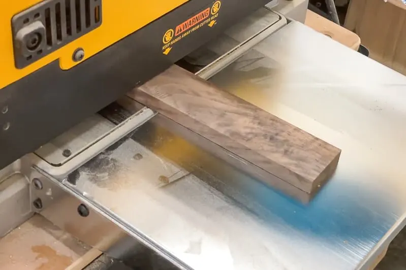 walnut board coming out of thickness planer