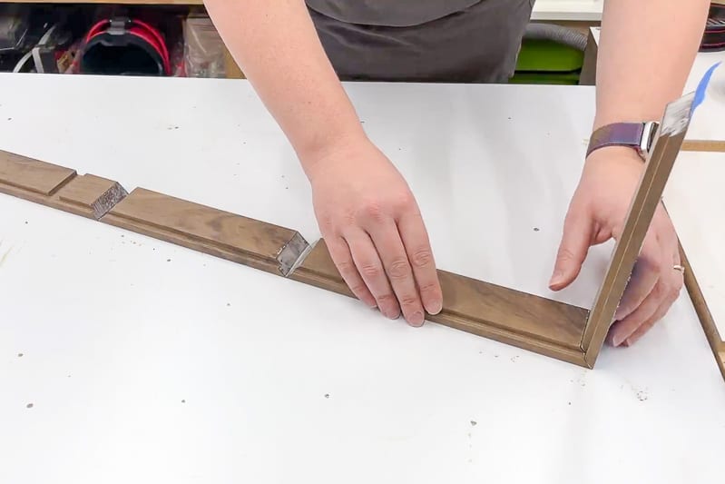 putting together mitered corners of dice tray with painter's tape and wood glue