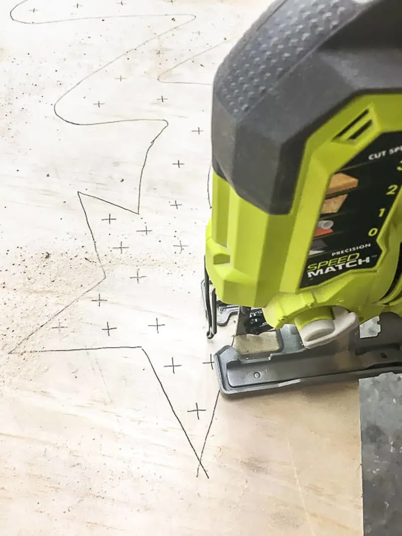 cutting out plywood Christmas tree with a jigsaw