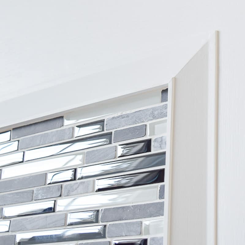 wainscot trim around mosaic tile fireplace