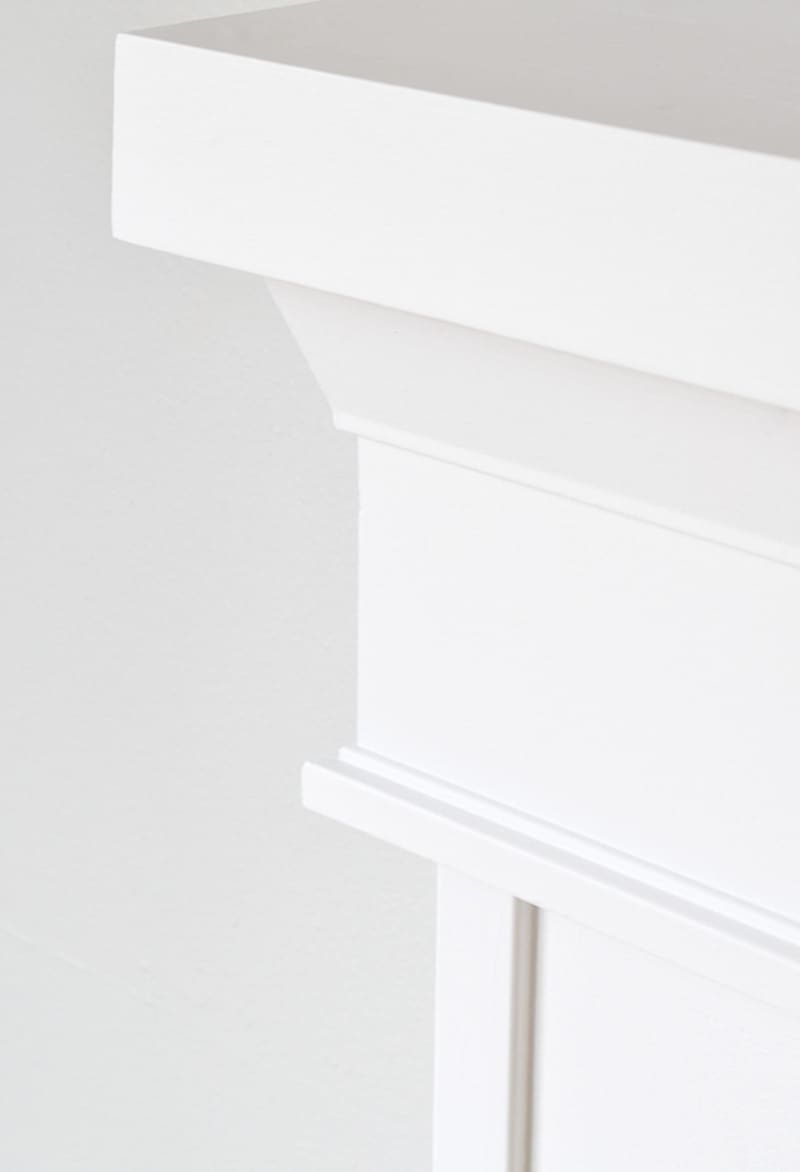 corner of fireplace mantel with trim underneath