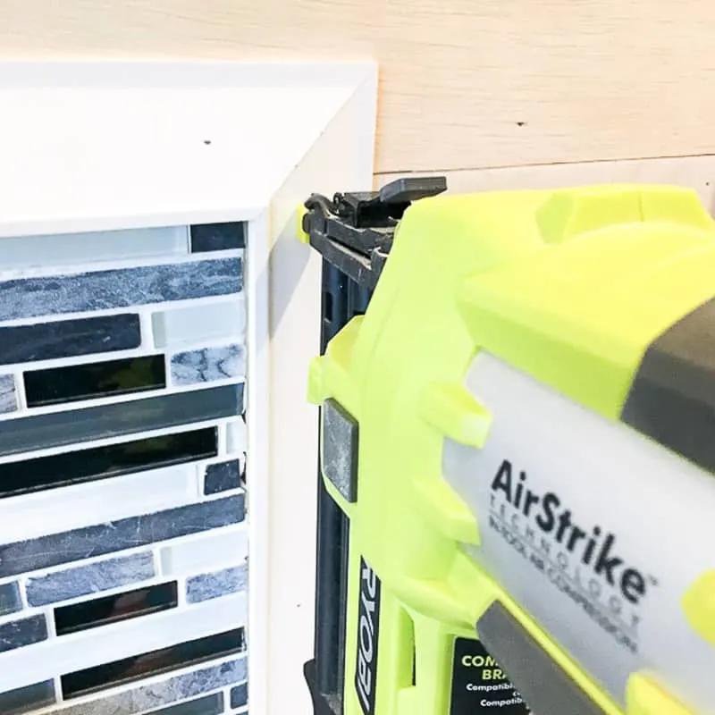 attaching wainscot trim to fireplace tile surround with nail gun