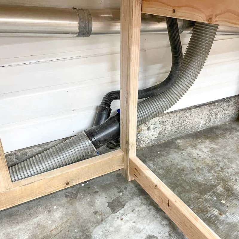 miter saw dust collection hose behind stand