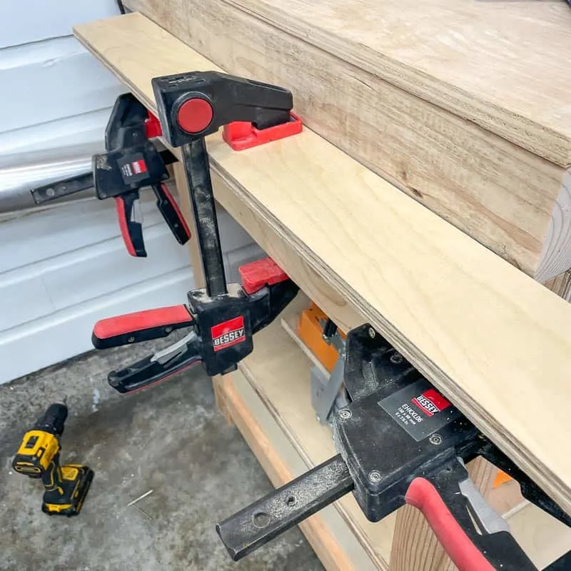 platform support for miter saw clamped to legs of miter saw station