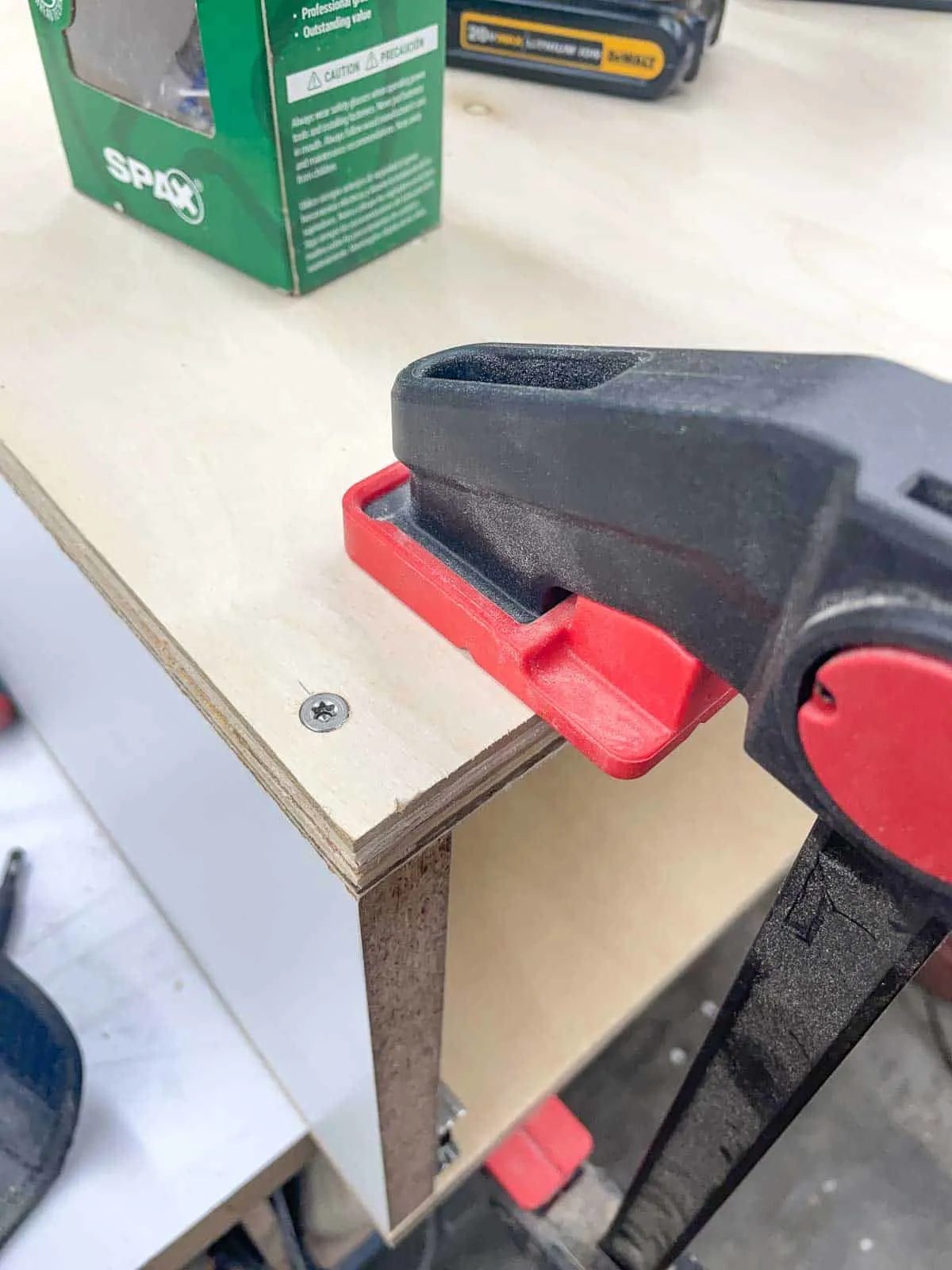 countersunk screws in top of planer stand with clamp holding pieces in place