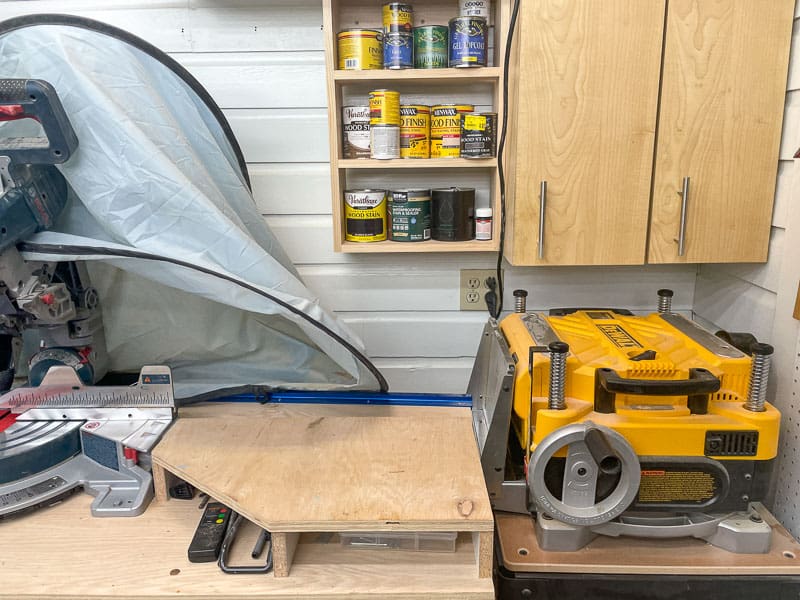 corner of workshop with cabinets,  planer and miter saw stand