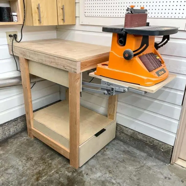 Flip-top wooden tool stand holding a benchtop machine