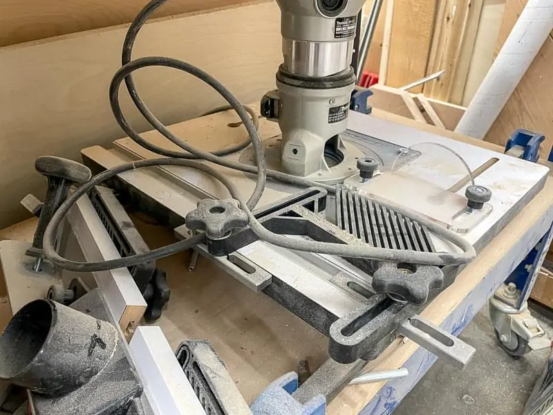 folding router table shoved under workbench