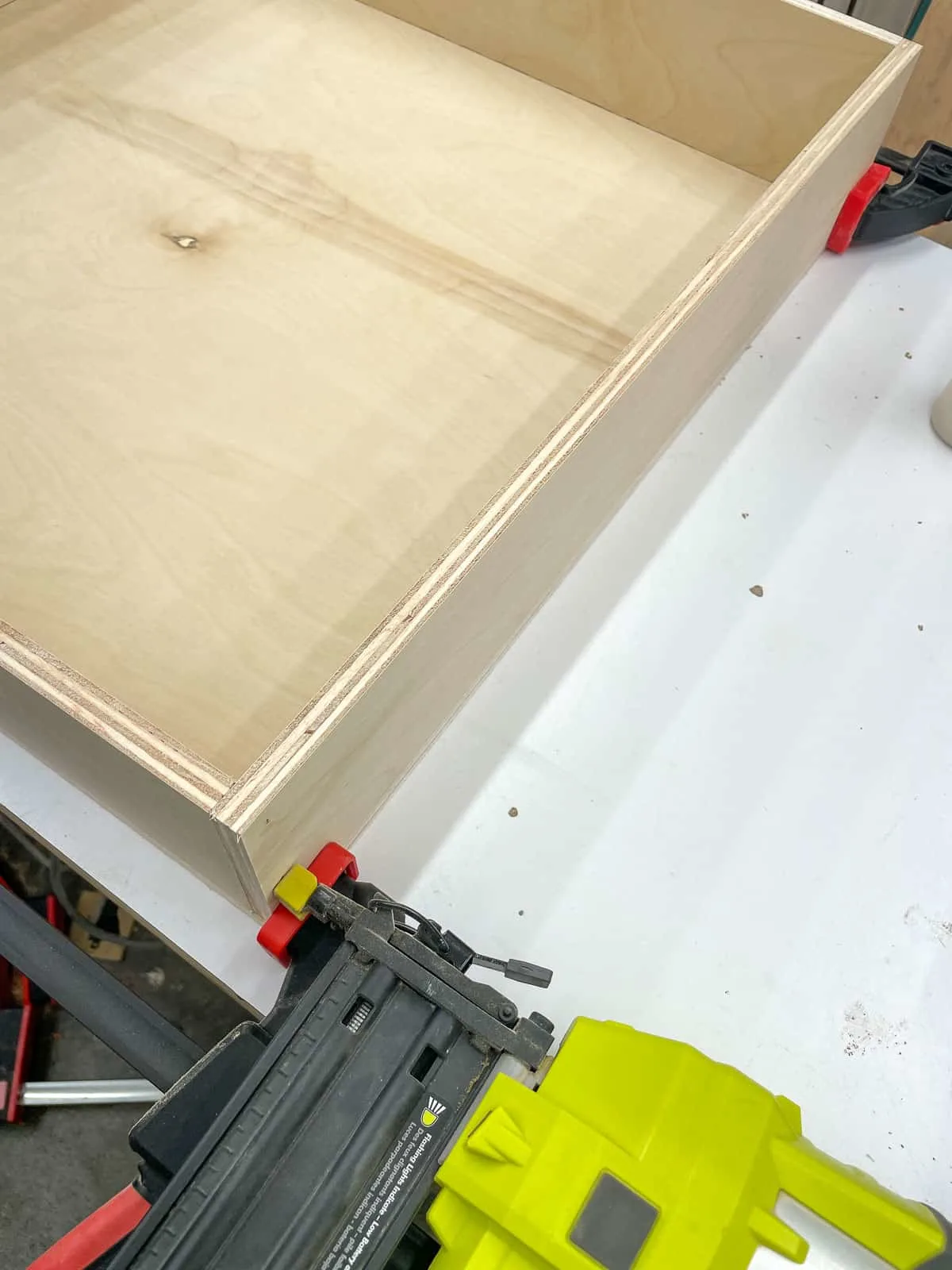 assembling a drawer box with clamps and brad nails