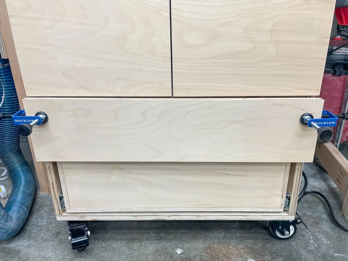 overlay drawer clamps holding drawer front in place on router table cabinet