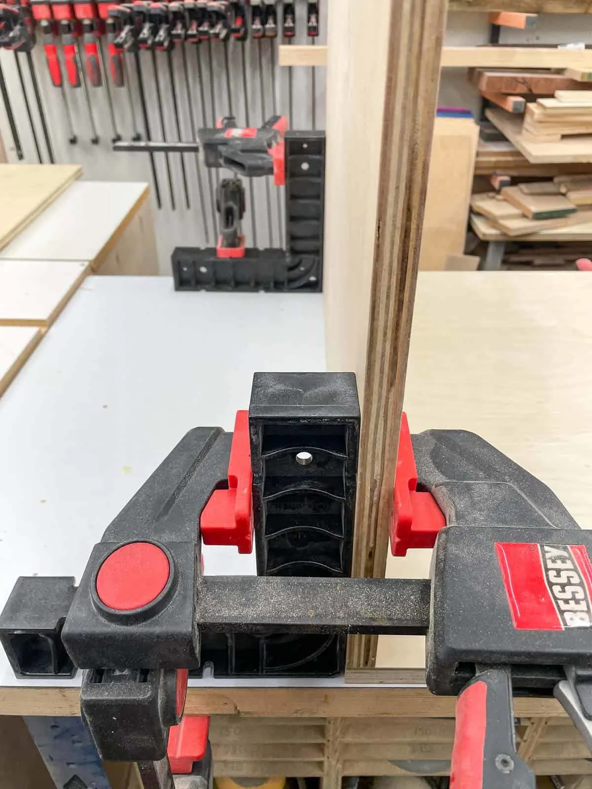 Right angle positioning squares and clamps holding router table sides at a 90 degree angle