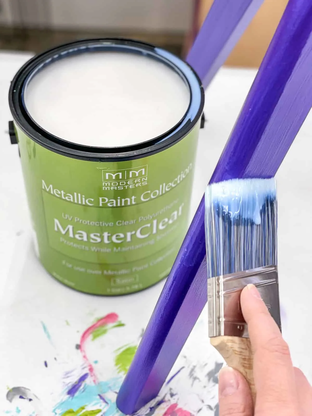 applying Modern Masters MasterClear top coat to purple metallic paint on chair leg