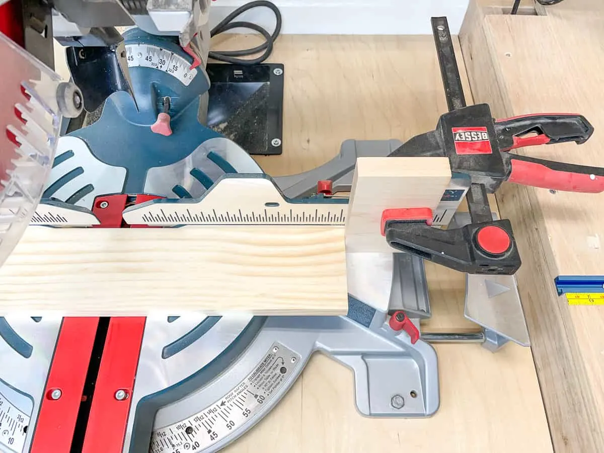 miter saw stop block clamped to saw fence