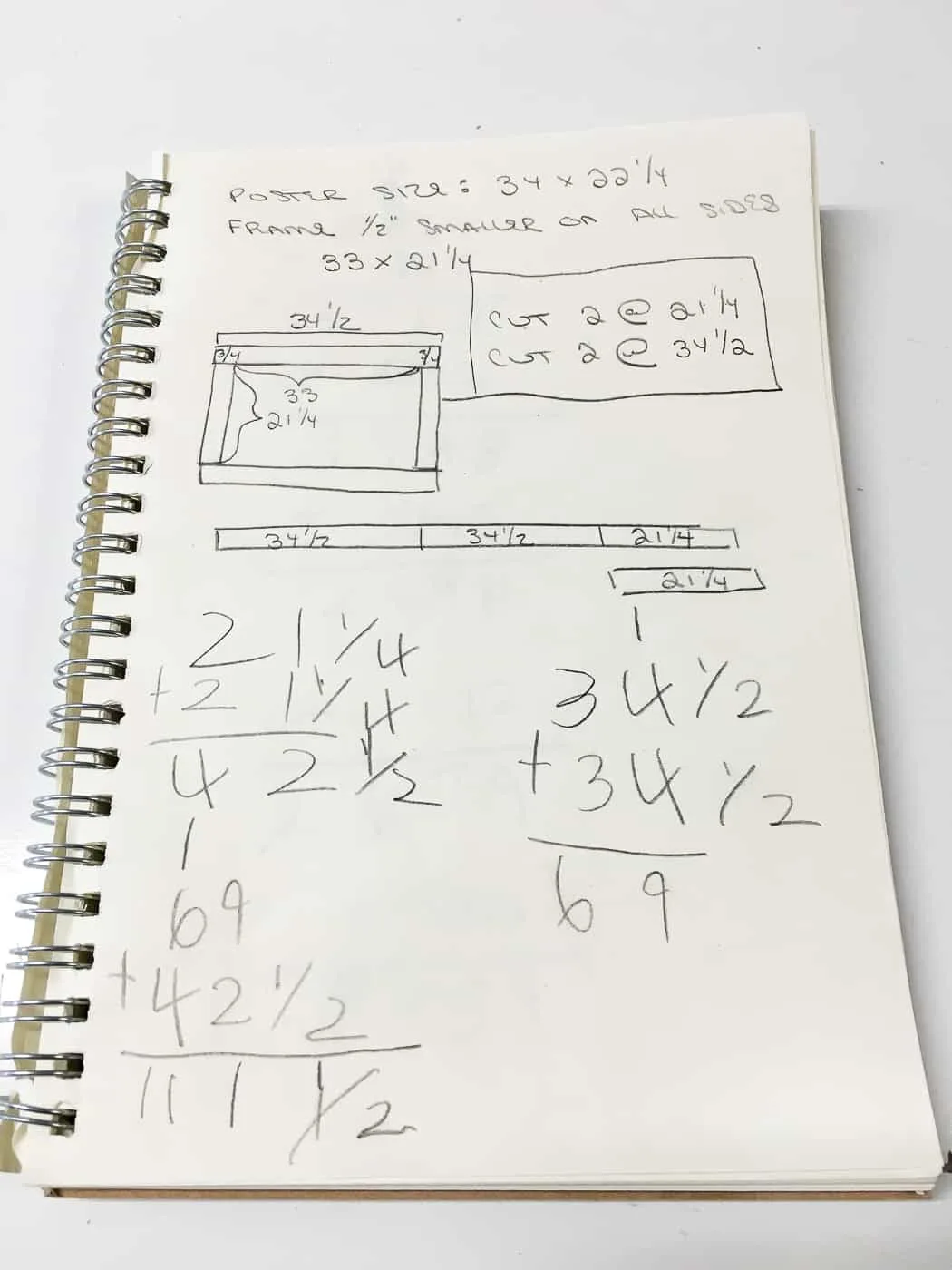 notebook with measurements for poster frame