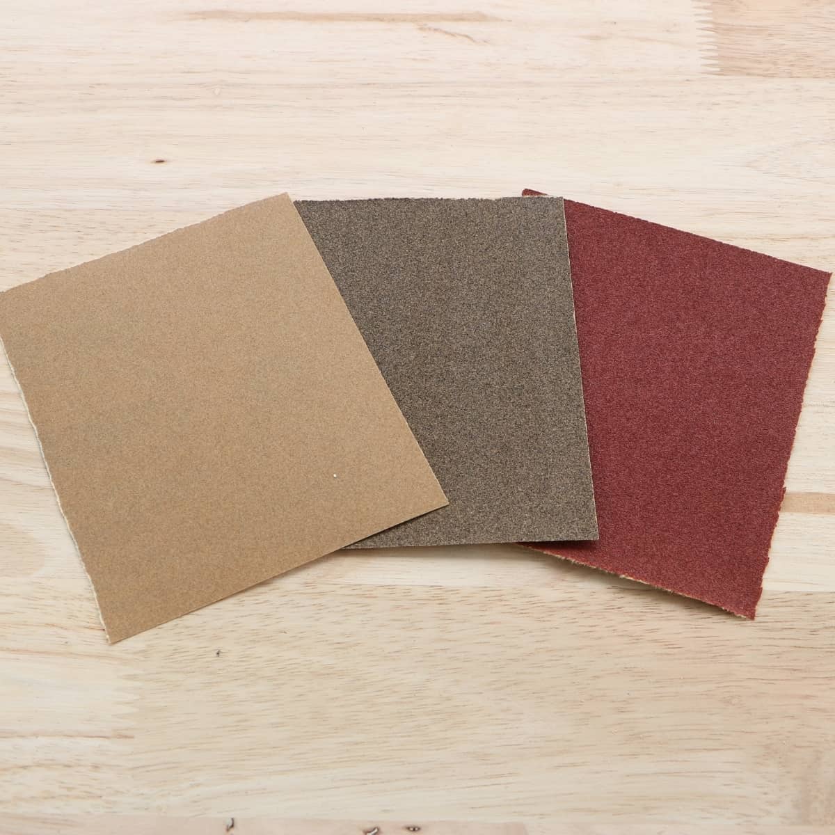 squares of sandpaper on wood surface