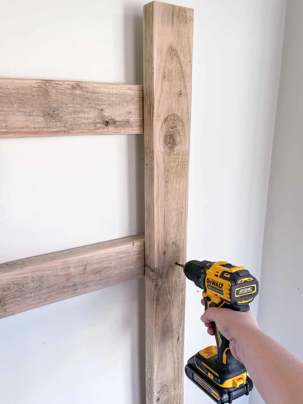 attaching vertical bike rack to horizontal supports on the wall