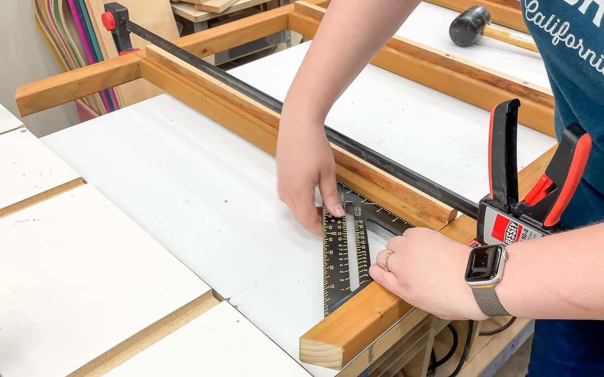 using clamps and a square before assembling front of mini greenhouse