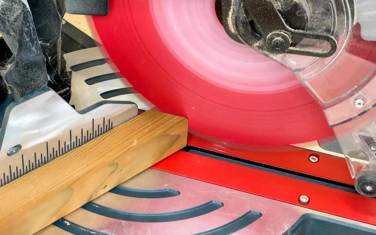 cutting end of 2x2 board at an angle with a miter saw