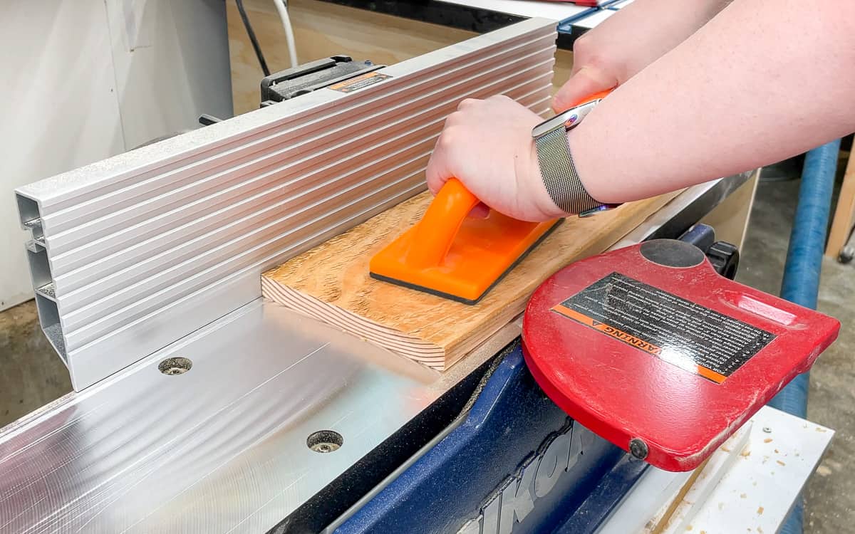 passing a board over a jointer blade