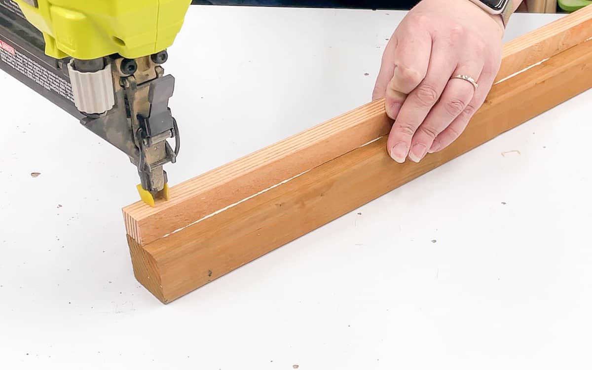 nailing the cleat for the removeable shelf of the mini greenhouse