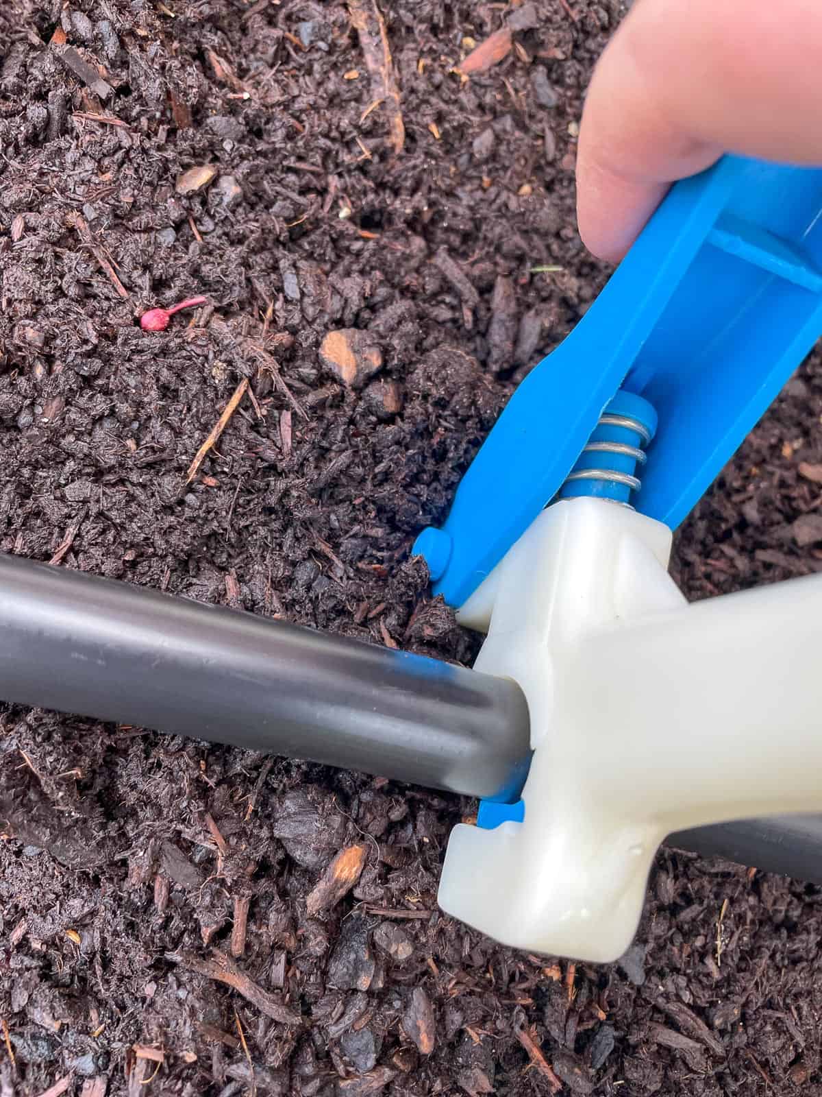 punching hole in drip tubing with special hole puncher