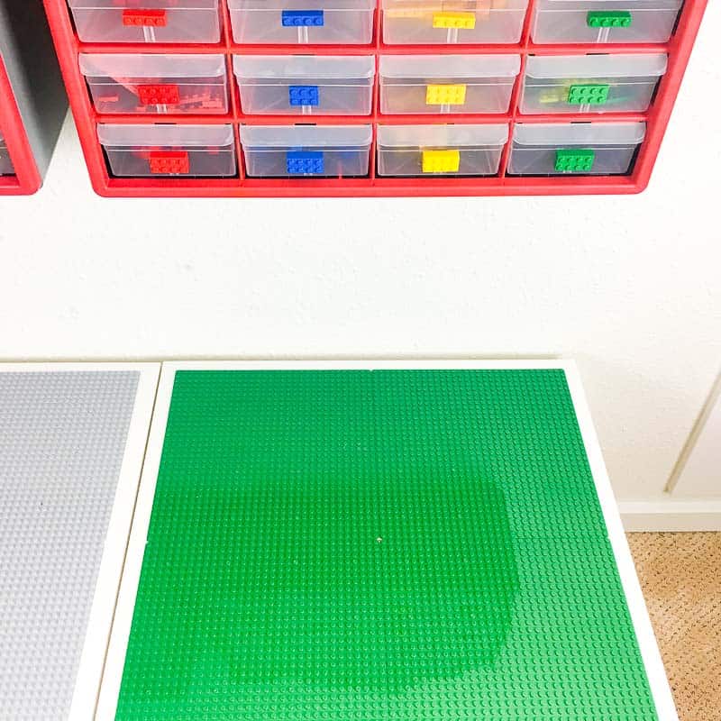 Lego table with small parts bins attached to the wall above