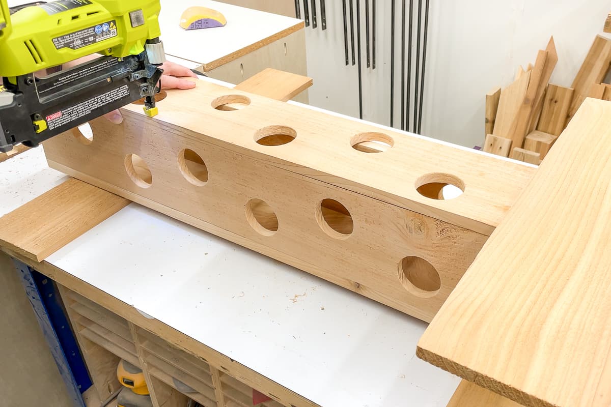 attaching front of strawberry planter with a brad nailer