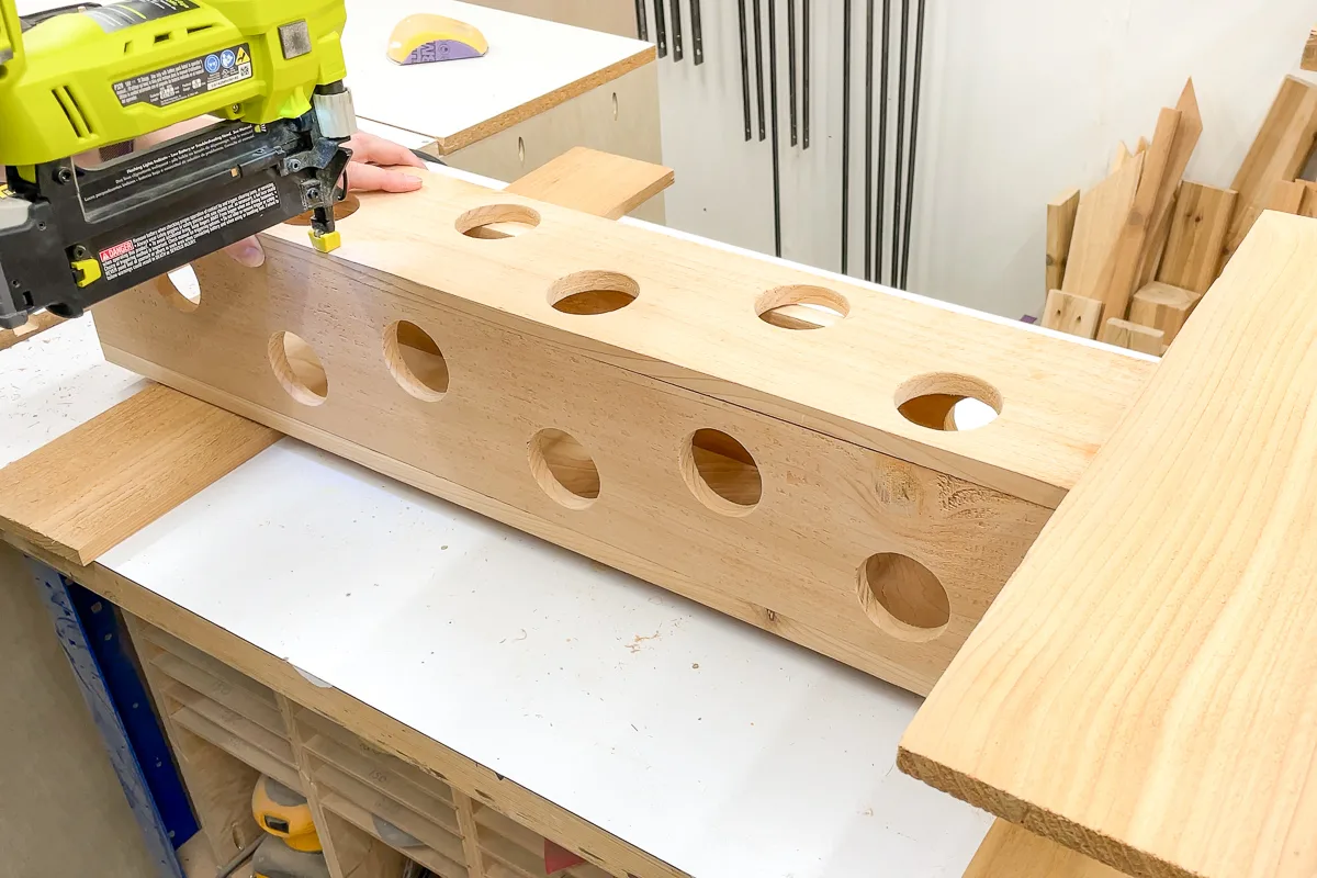 attaching front of strawberry planter with a brad nailer