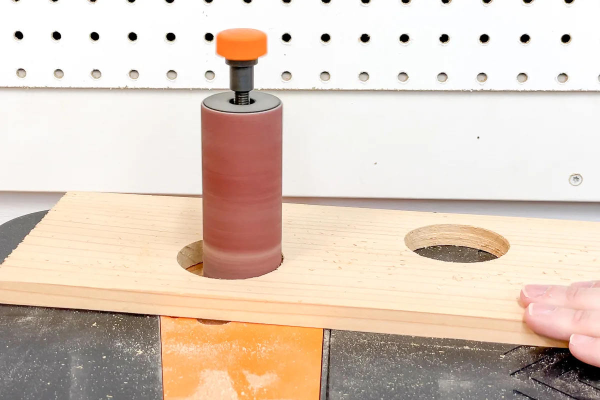 spindle sander sanding inside of holes in DIY strawberry planter