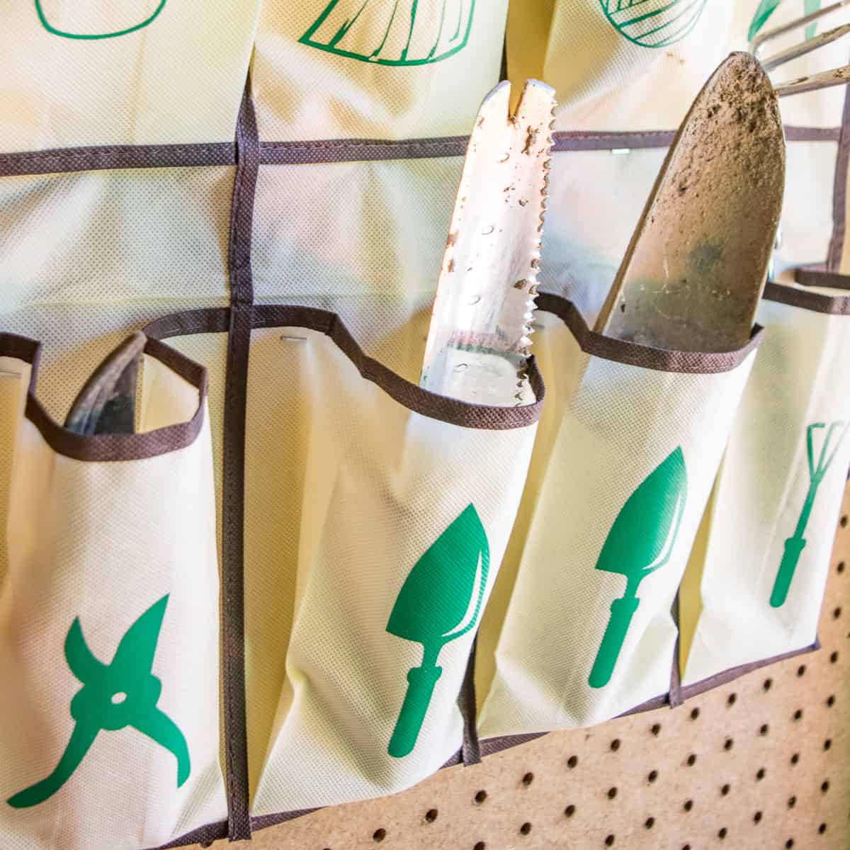 hanging garden tool organizer with labeled pockets for hand gardening tools