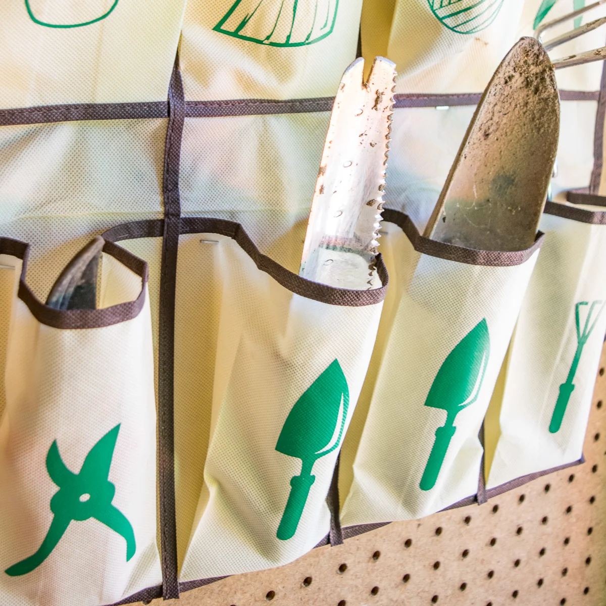 hanging garden tool organizer with labeled pockets for hand gardening tools