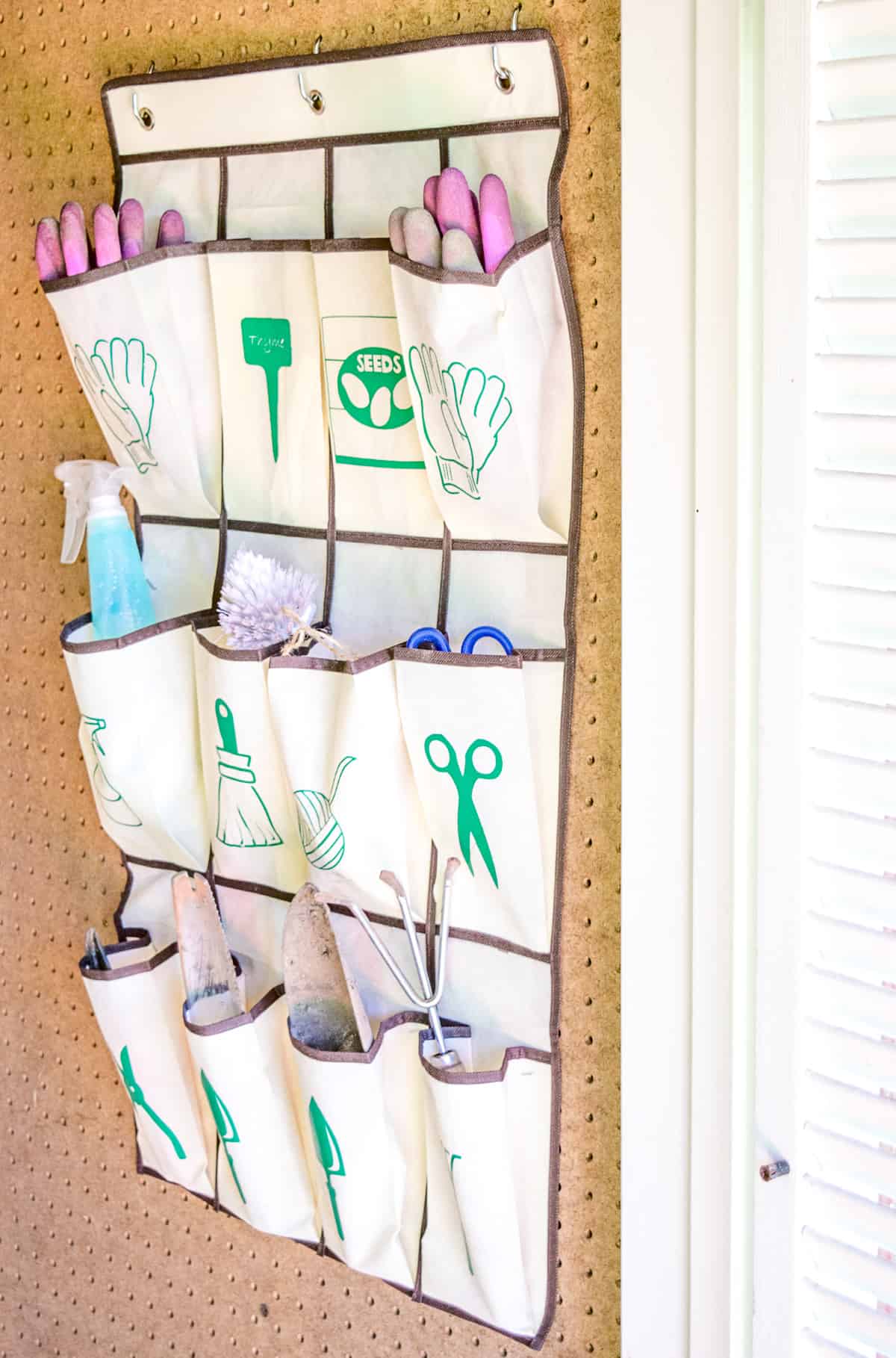 hanging garden tool organizer in shed on pegboard wall