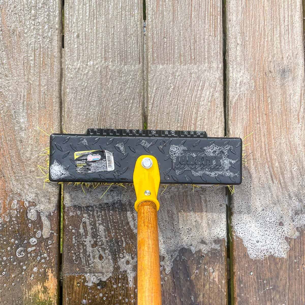 scrubbing deck with homemade deck cleaner