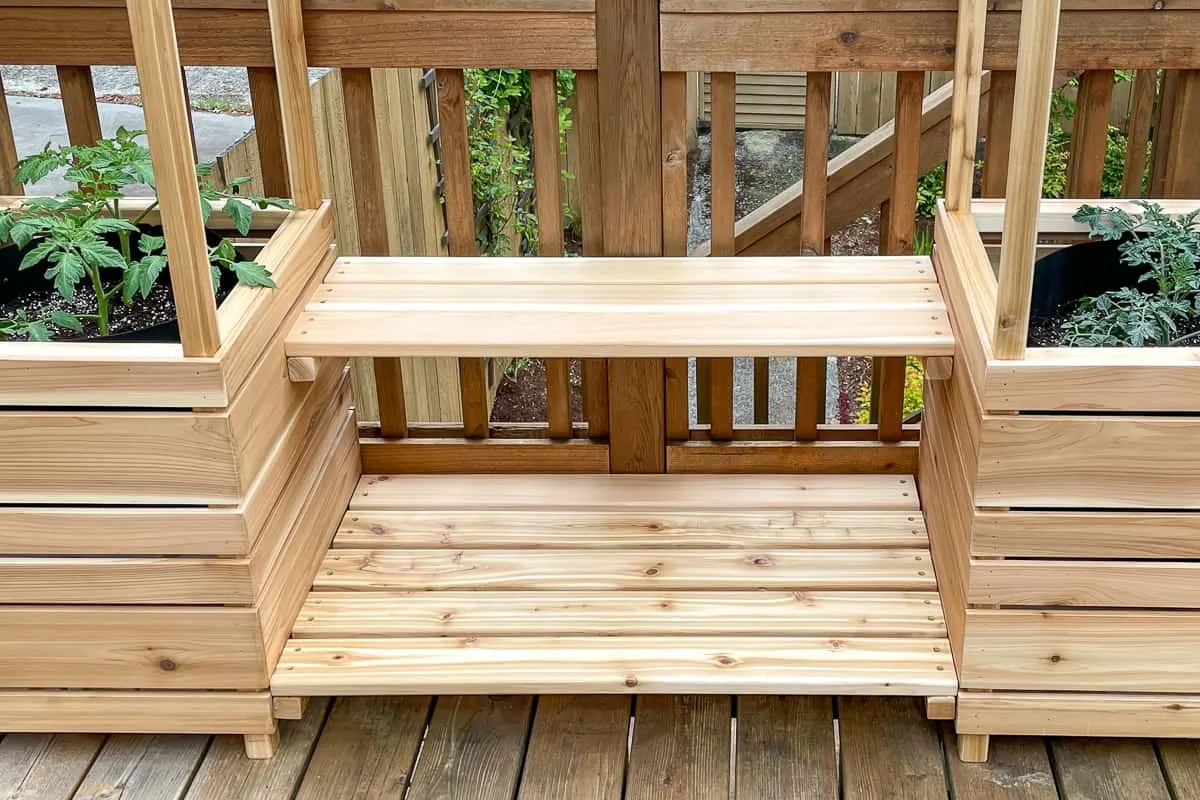 plant stand shelves attached to the side of two planter boxes