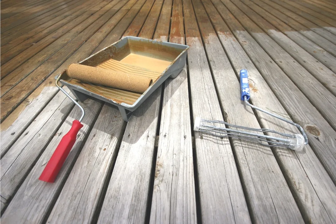 applying deck stain with a roller