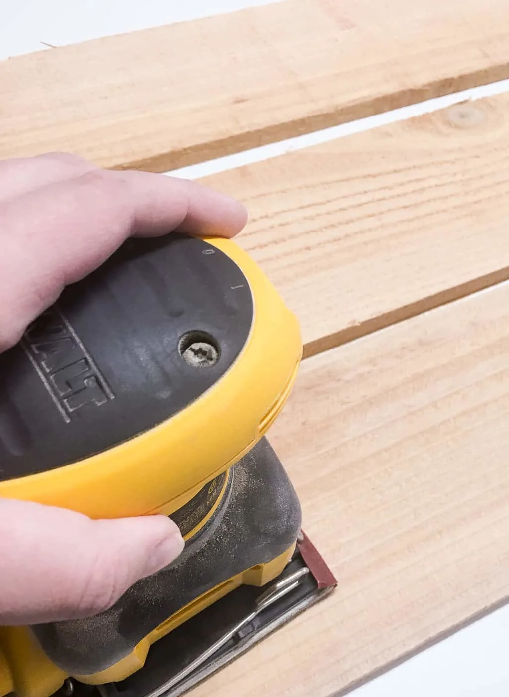 sanding cedar fence pickets with a palm sander