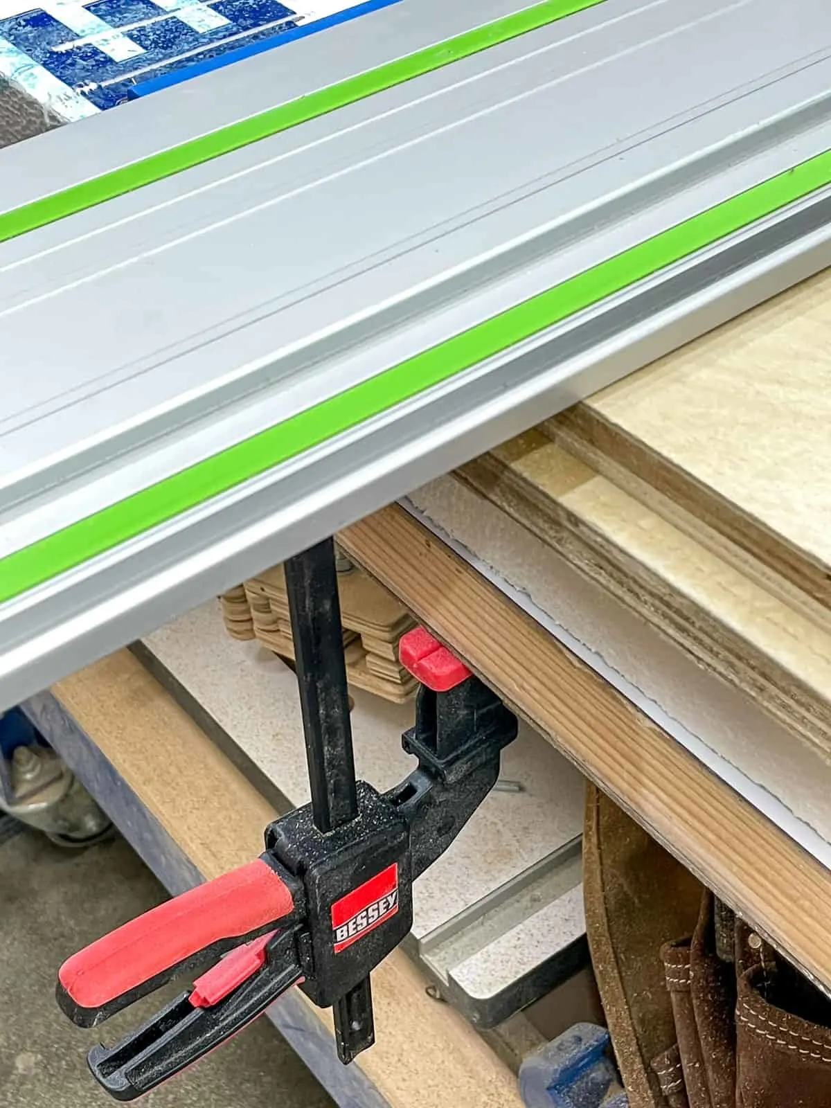 track for track saw secured to workbench with bessey clamp