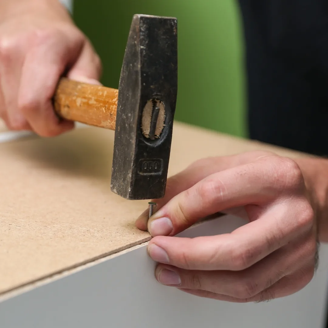 attaching cabinet back panel with a hammer and panel nails