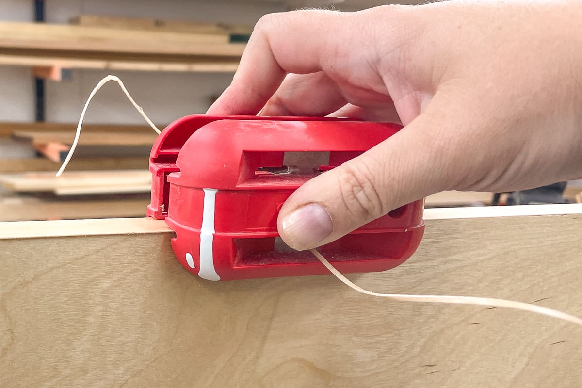 trimming edge banding on plywood cabinet box side