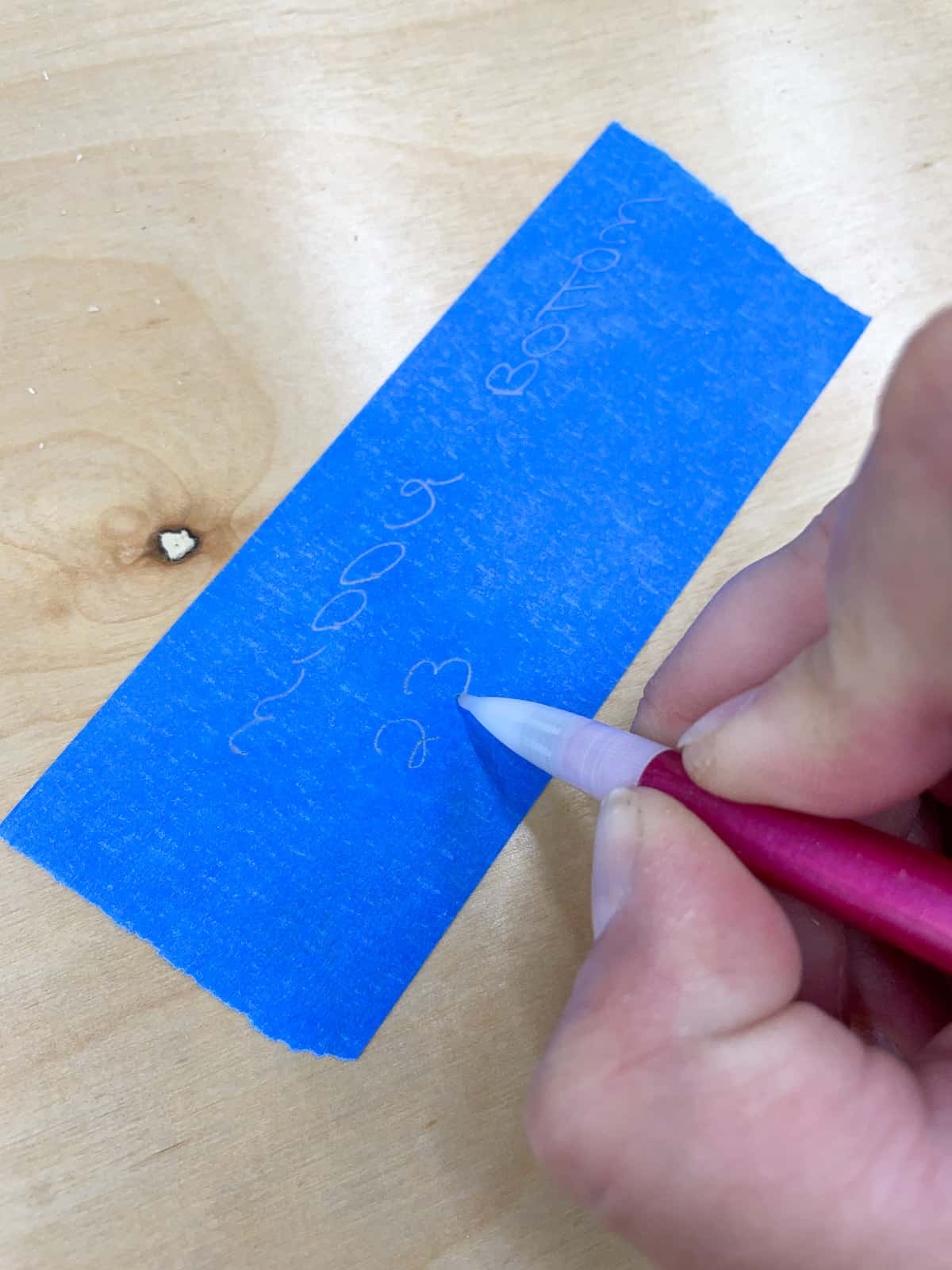 blue painter's tape label on cabinet box parts