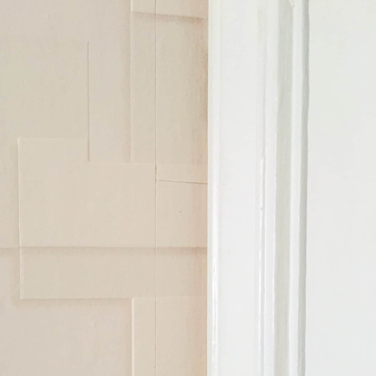 textured wallpaper behind door trim