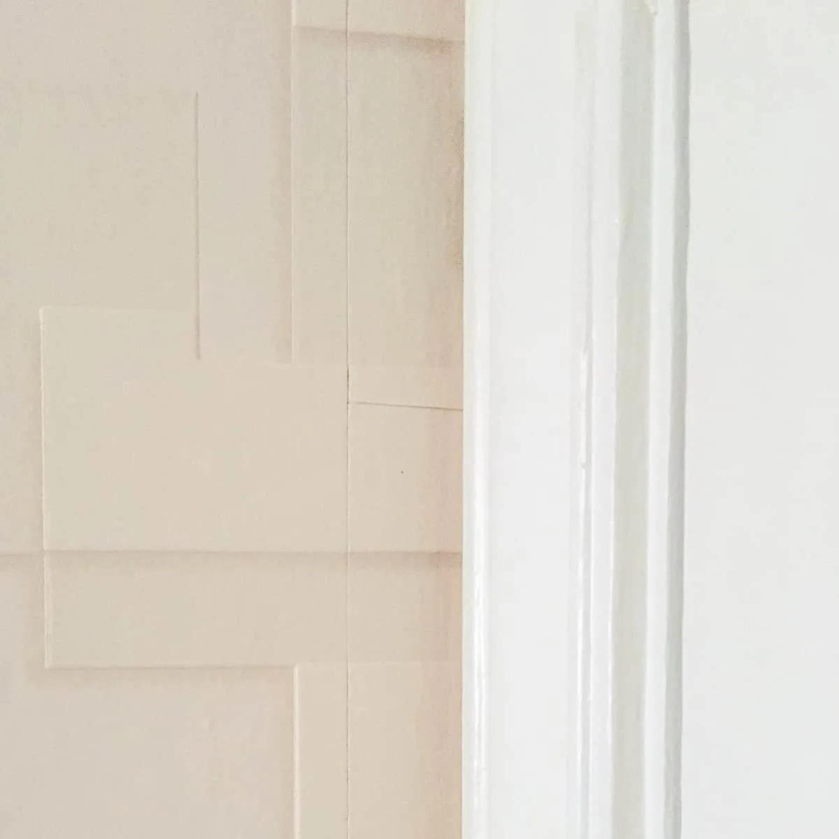 textured wallpaper behind door trim
