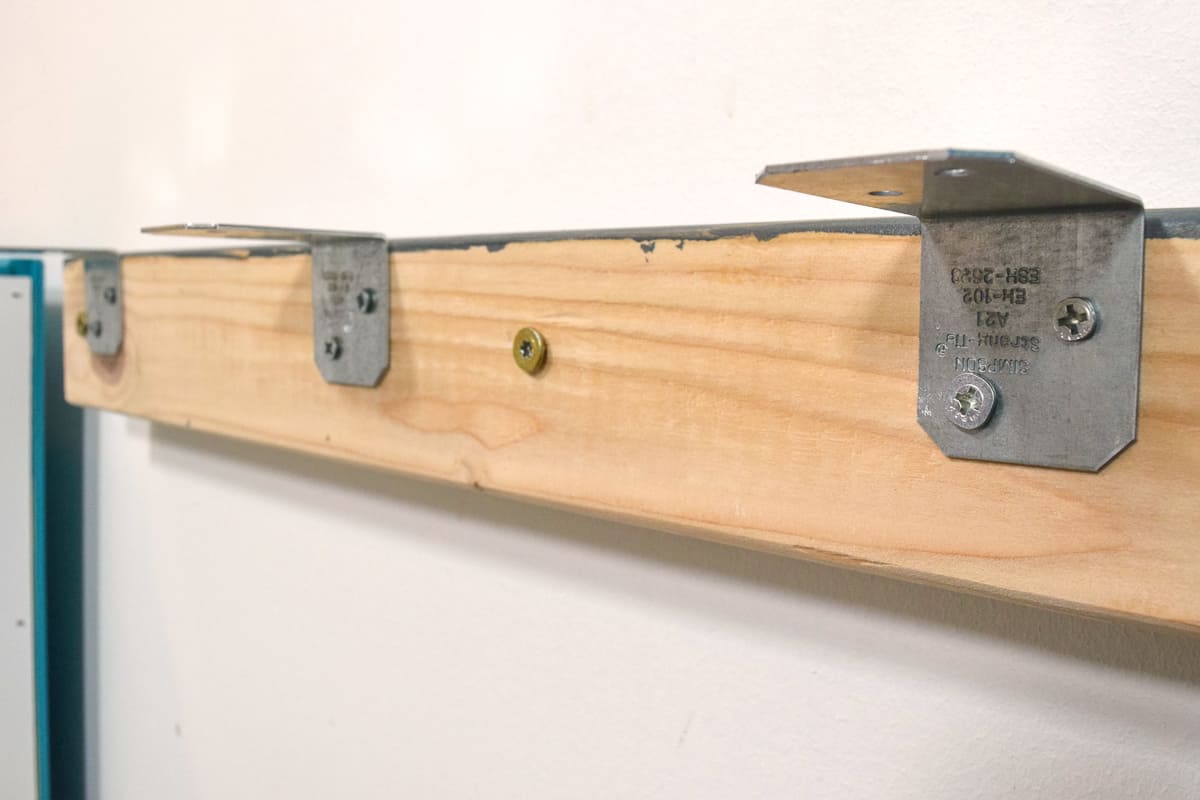angle brackets on wall cleat to support the back of the desktop