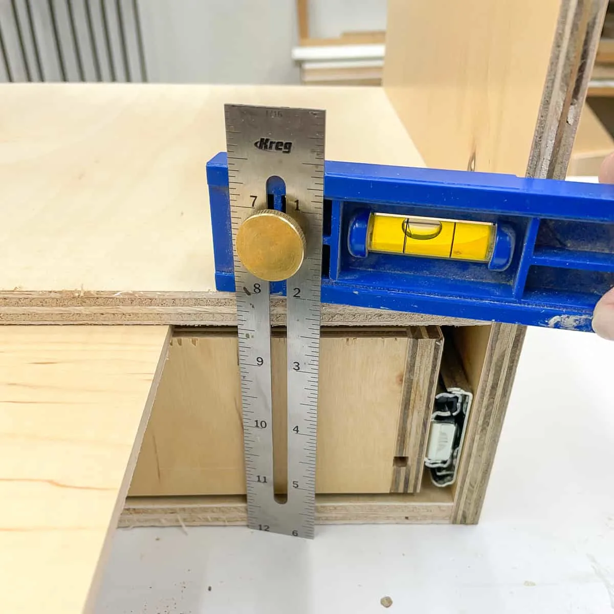 measuring height of the shelf inside the nail gun storage box