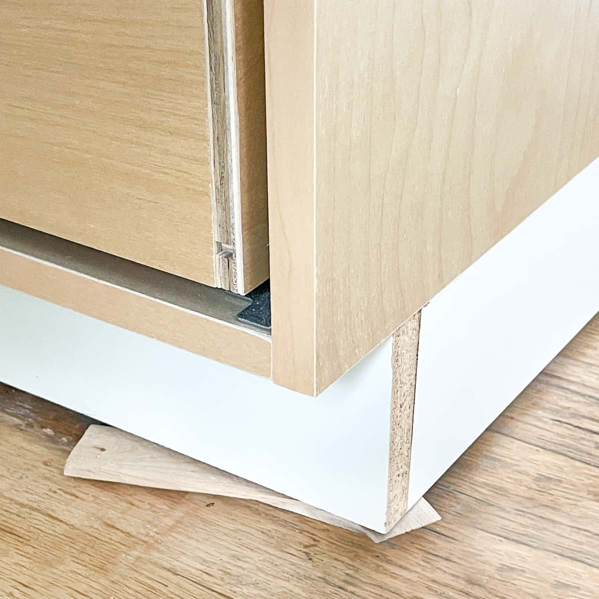 shims under toe kick platform to make the countertop level